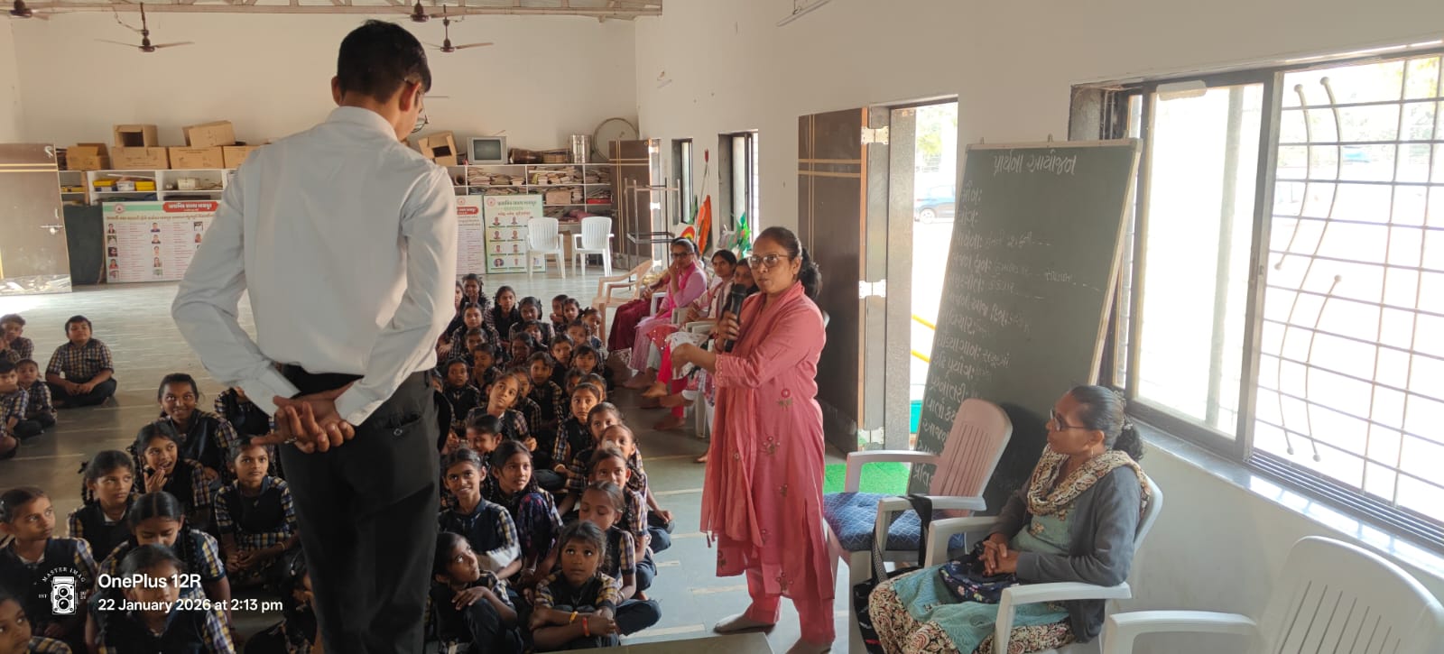 Dr. Naik at a school gathering with students and faculty